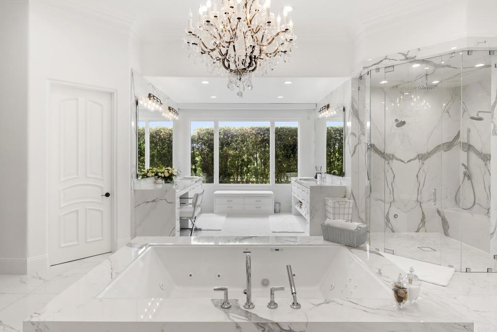 6853 Rancho Valencia Road Rancho Santa Fe, CA 92067 - Photo 15 of 40 a bathroom with a tub sink and large window