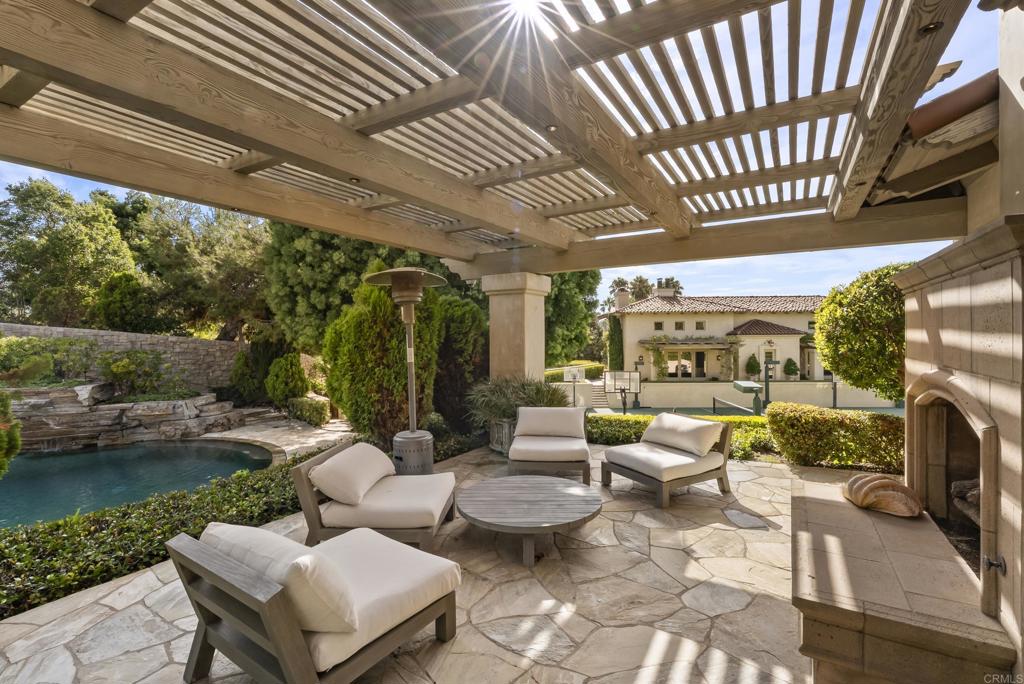 6853 Rancho Valencia Road Rancho Santa Fe, CA 92067 - Photo 22 of 40 a outdoor living space with furniture and garden view