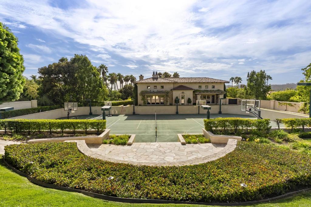 6853 Rancho Valencia Road Rancho Santa Fe, CA 92067 - Photo 23 of 40 a view of a swimming pool with a house