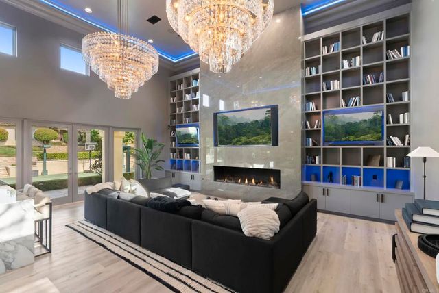 a living room with furniture a large window and a flat screen tv