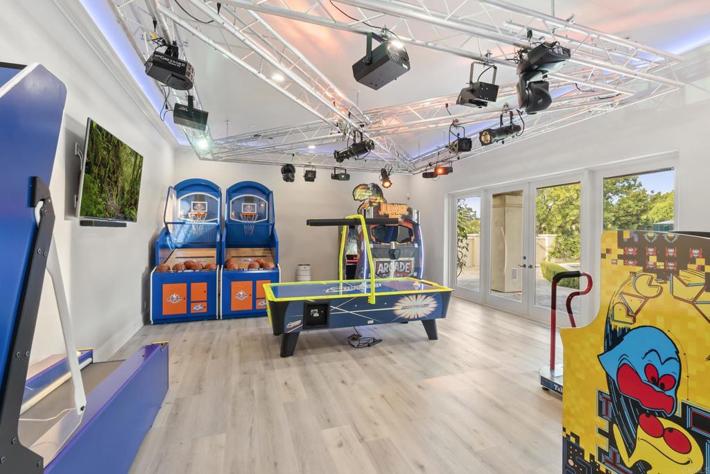 6853 Rancho Valencia Road Rancho Santa Fe, CA 92067 - Photo 27 of 40 a living room with furniture and a book shelf