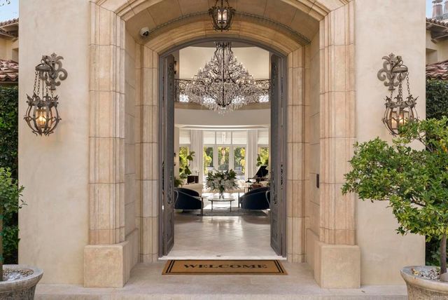 a view of living room filled with furniture and a potted plant