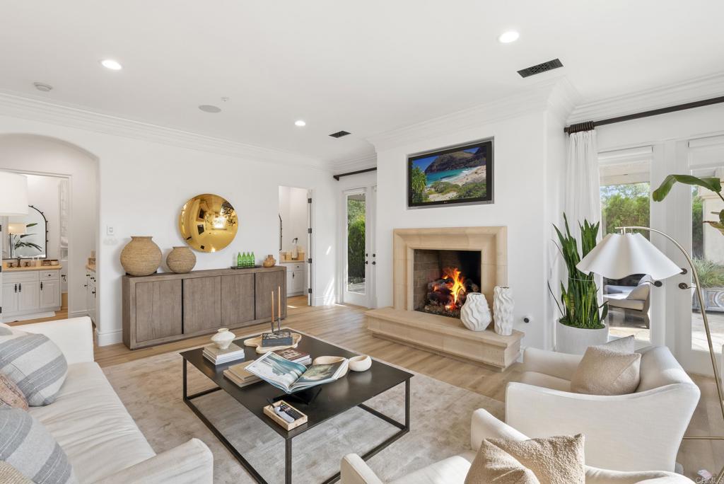 6853 Rancho Valencia Road Rancho Santa Fe, CA 92067 - Photo 34 of 40 a living room with furniture and a fireplace