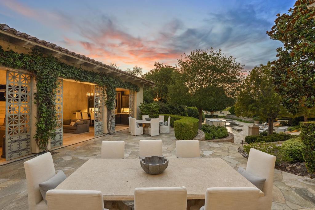 6853 Rancho Valencia Road Rancho Santa Fe, CA 92067 - Photo 36 of 40 a view of a patio with couches table and chairs and potted plants