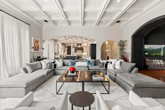 a living room with furniture and a chandelier