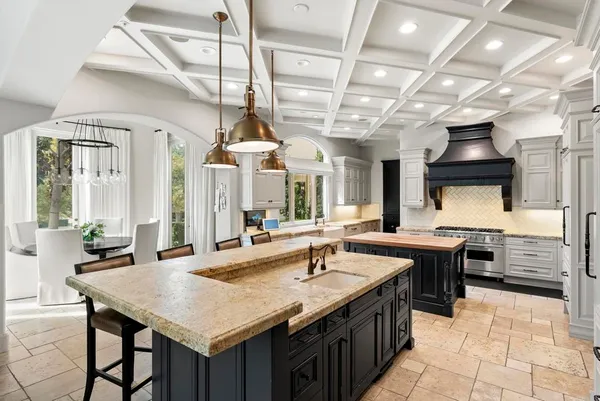 a kitchen with stainless steel appliances granite countertop a sink and cabinets