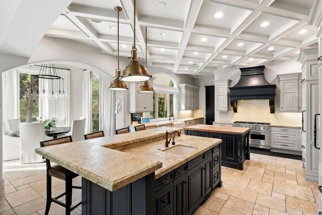 a kitchen with stainless steel appliances granite countertop a sink and cabinets