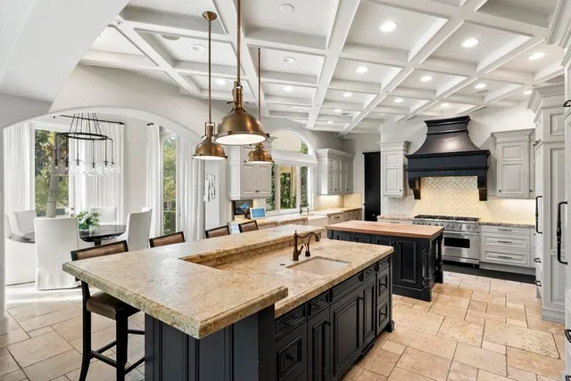 a kitchen with stainless steel appliances granite countertop a sink and cabinets