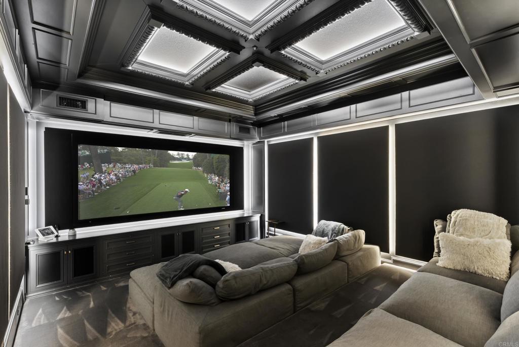 6853 Rancho Valencia Road Rancho Santa Fe, CA 92067 - Photo 10 of 40 a living room with furniture and a flat screen tv