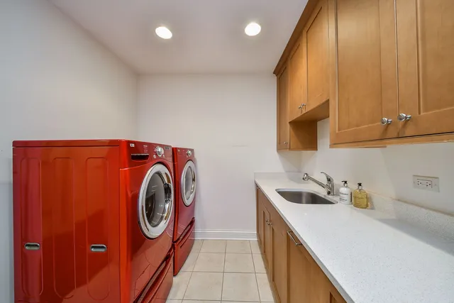 a utility room with sink dryer and washer