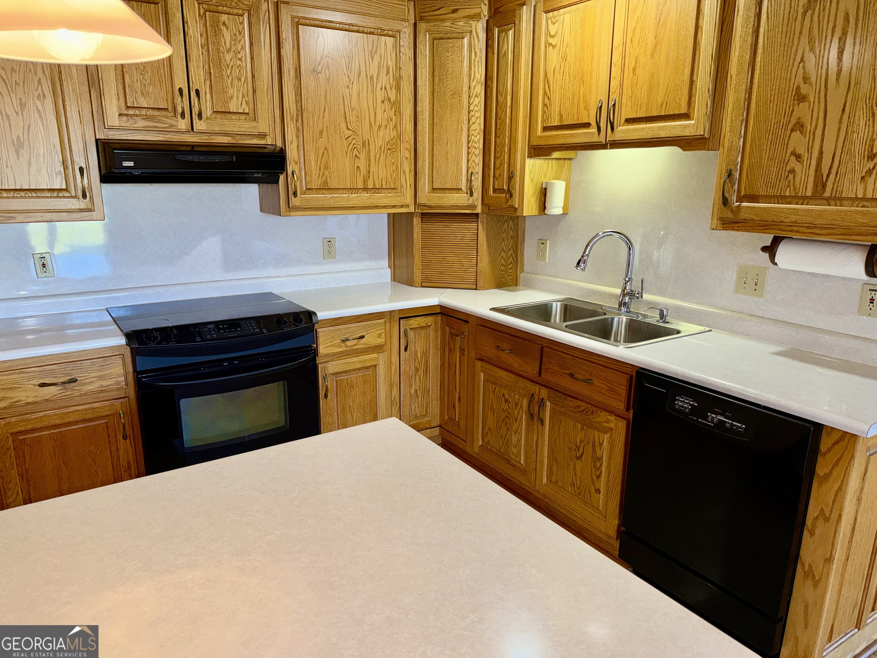494 Broad Street Bowman, GA 30624 - Photo 25 of 65 a kitchen with a sink a stove and cabinets