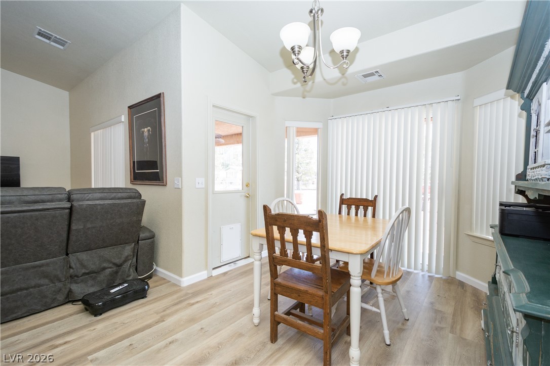 2381 Tough Boy Road Pahrump, NV 89060 - Photo 13 of 44 This bright dining area features an open layout, durable flooring, and a door leading to outdoor space.