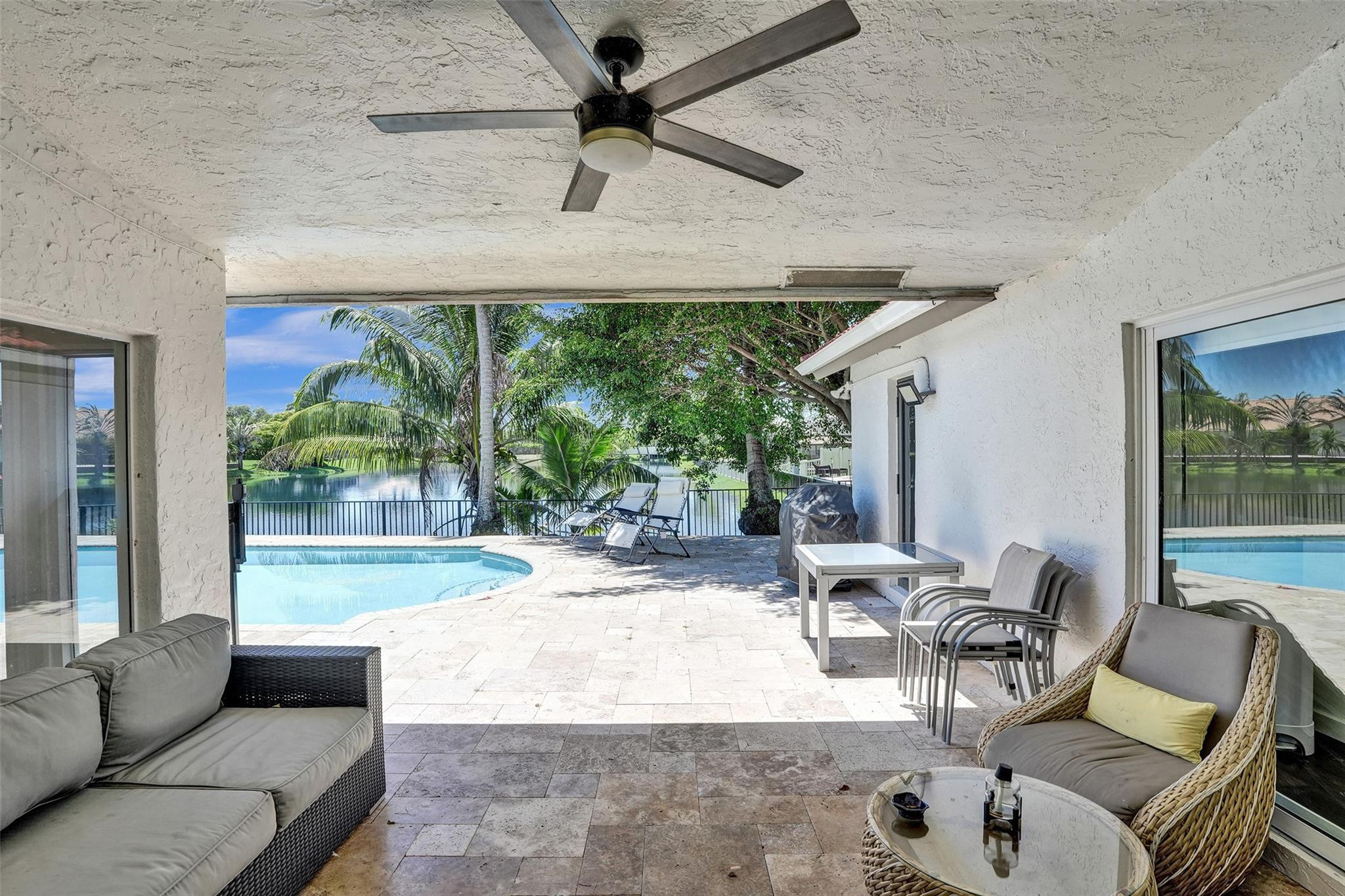 10130 Northwest 13th Street Plantation, FL 33322 - Photo 16 of 23 a living room with patio furniture and a large window