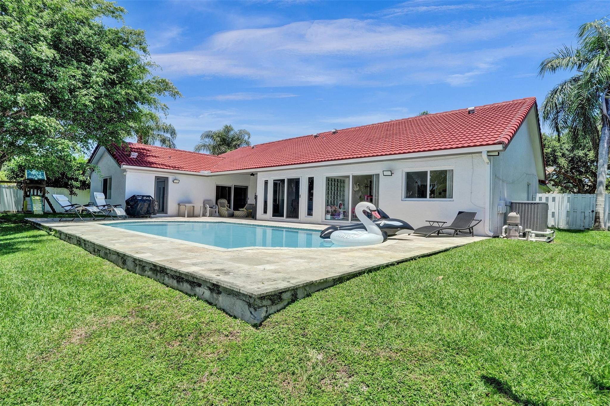 10130 Northwest 13th Street Plantation, FL 33322 - Photo 19 of 23 a view of house with a big yard and potted plants