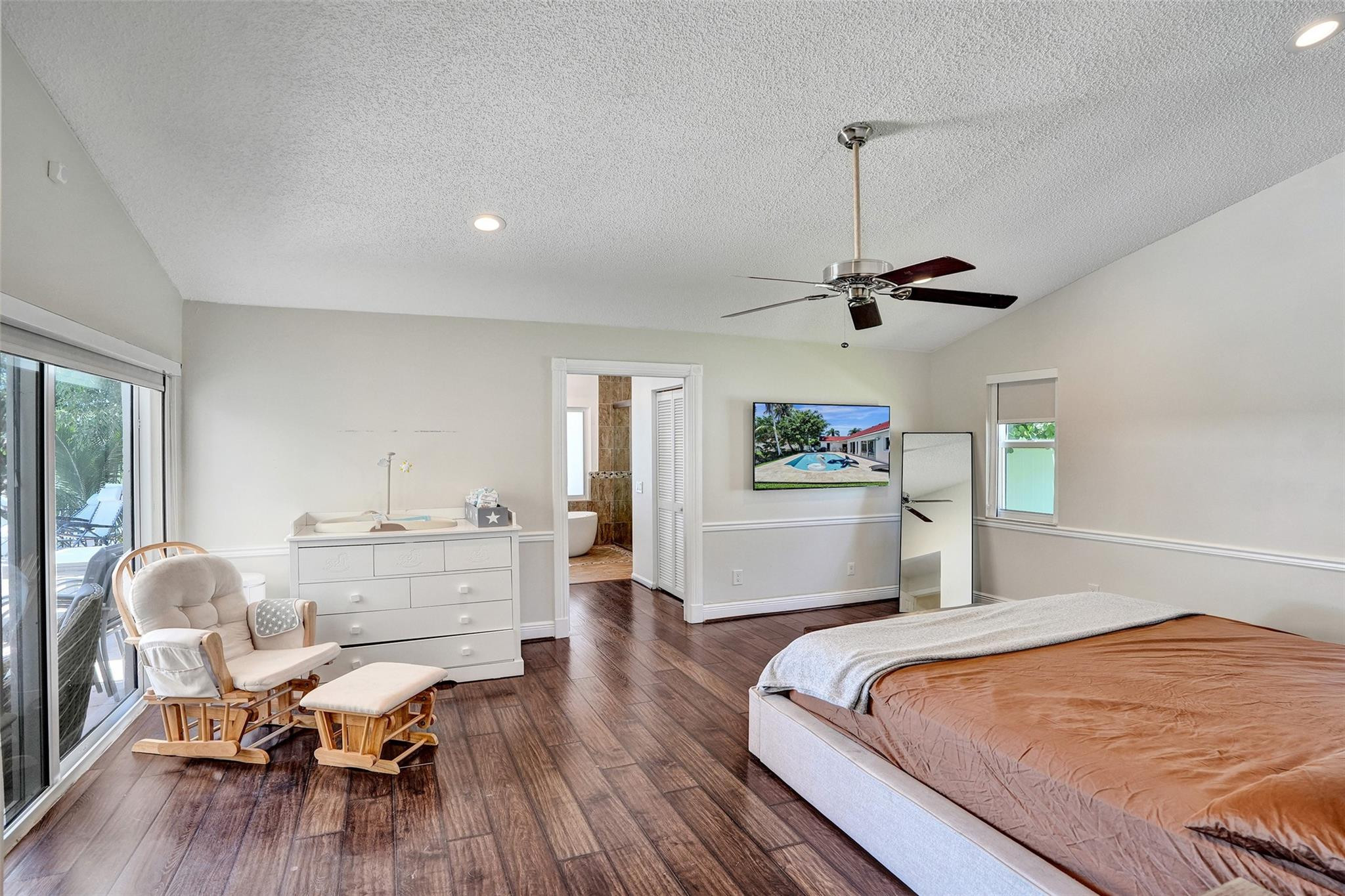 10130 Northwest 13th Street Plantation, FL 33322 - Photo 6 of 23 a bedroom with a bed and wooden floor