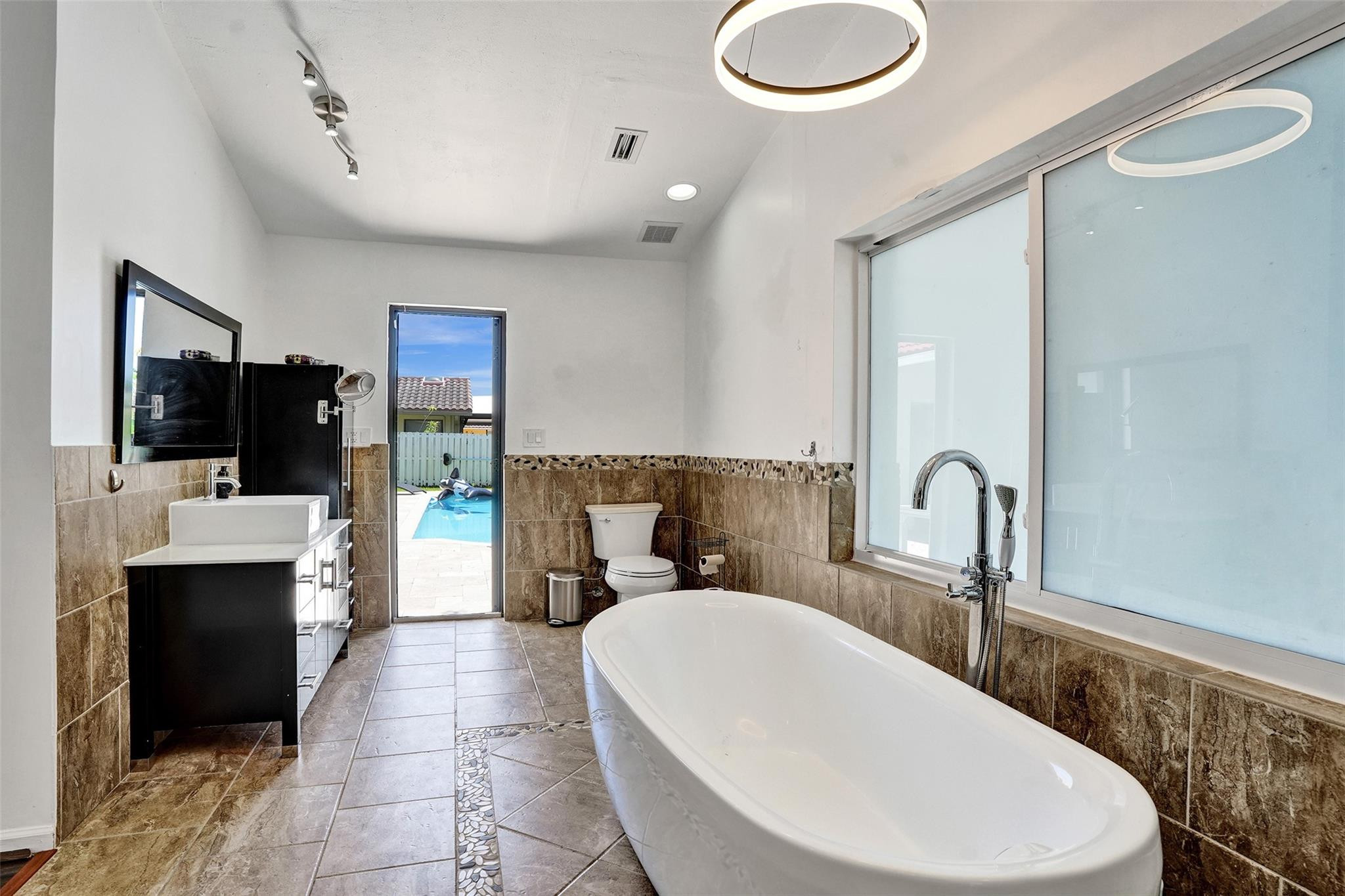 10130 Northwest 13th Street Plantation, FL 33322 - Photo 8 of 23 a bathroom with a sink and a mirror
