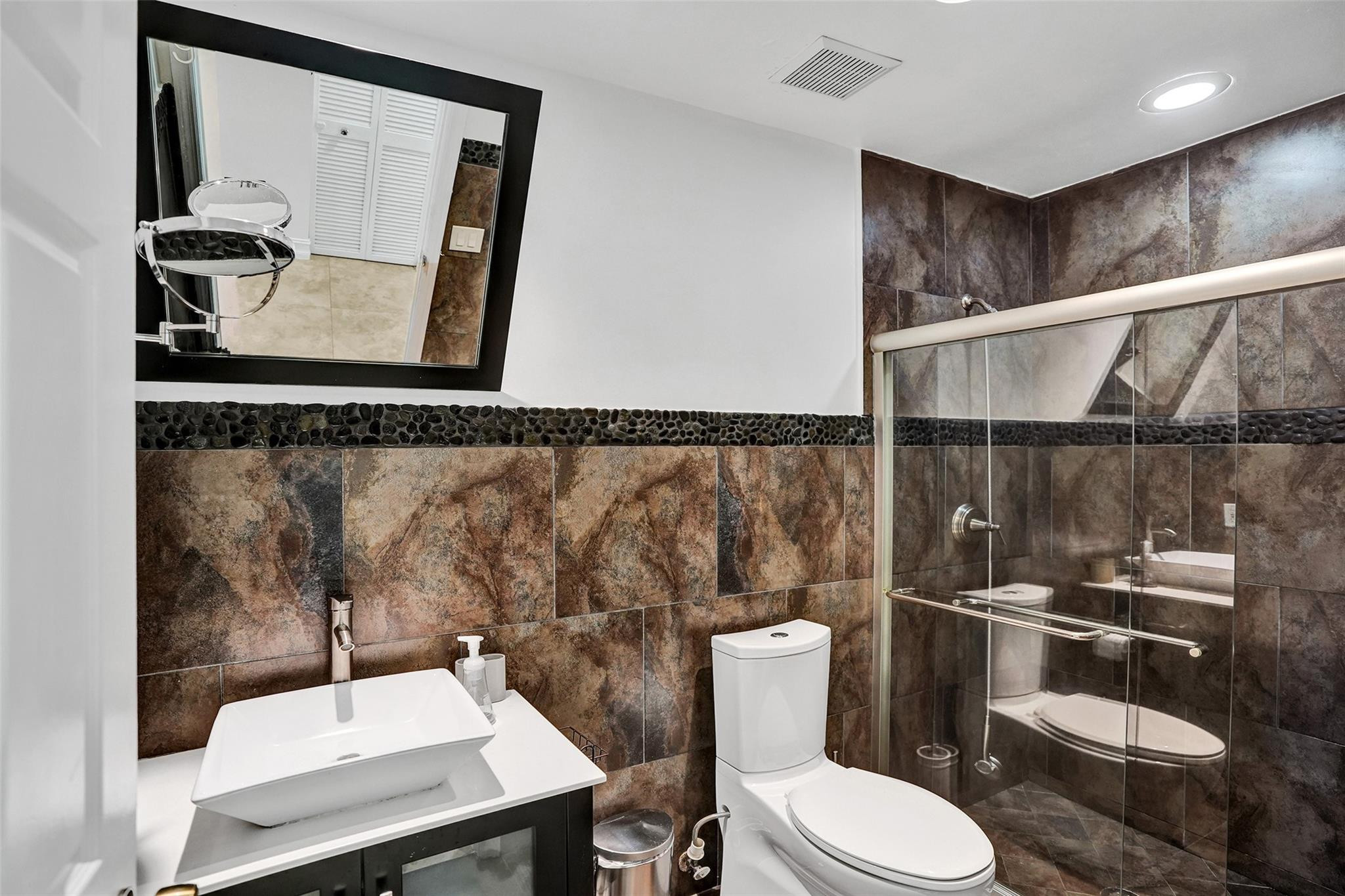 10130 Northwest 13th Street Plantation, FL 33322 - Photo 10 of 23 a bathroom with a toilet a sink and mirror