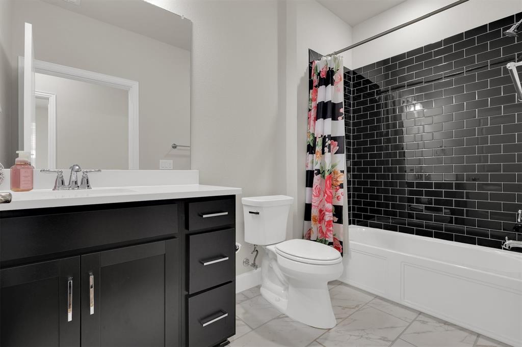 651 Watters Road, Unit 2105 Allen, TX 75013 - Photo 15 of 32 a bathroom with a sink toilet vanity and shower