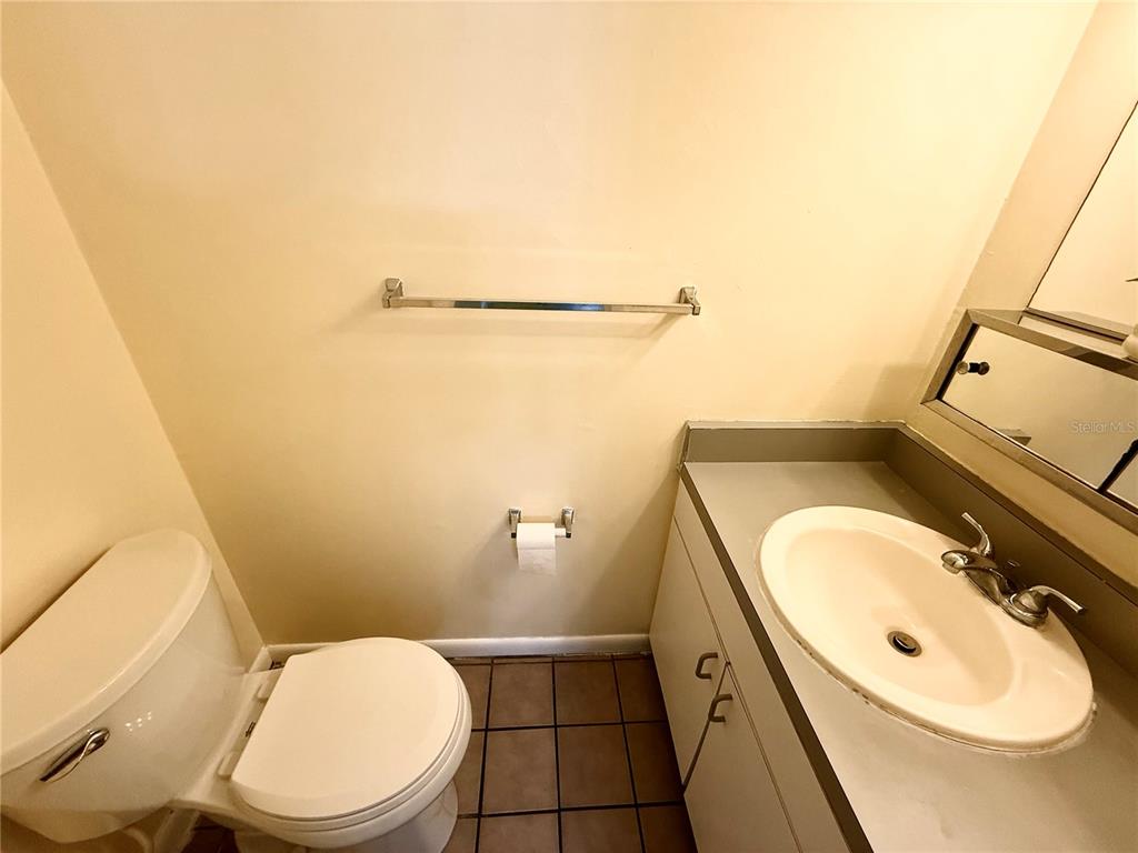 2735 Southwest 35th Place, Unit 1604 Gainesville, FL 32608 - Photo 14 of 25 a bathroom with a granite countertop toilet and a sink