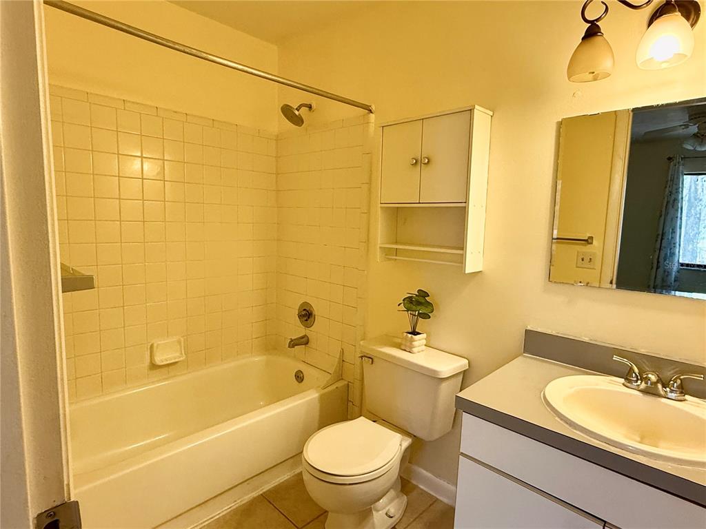 2735 Southwest 35th Place, Unit 1604 Gainesville, FL 32608 - Photo 20 of 25 a bathroom with a sink a toilet and shower