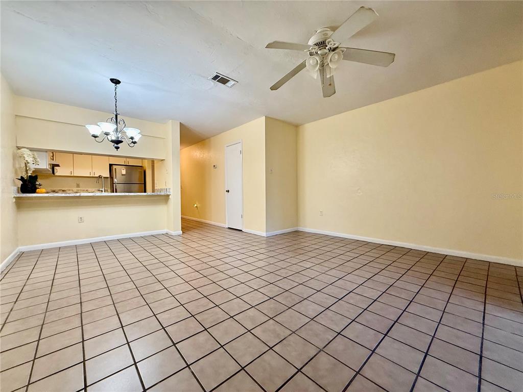 2735 Southwest 35th Place, Unit 1604 Gainesville, FL 32608 - Photo 4 of 25 a view of a livingroom with a chandelier fan and fire place