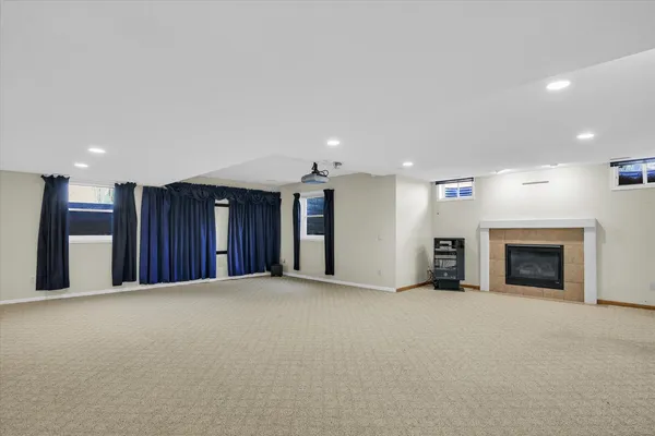 an aerial view of a house with a swimming pool yard and lake view in back