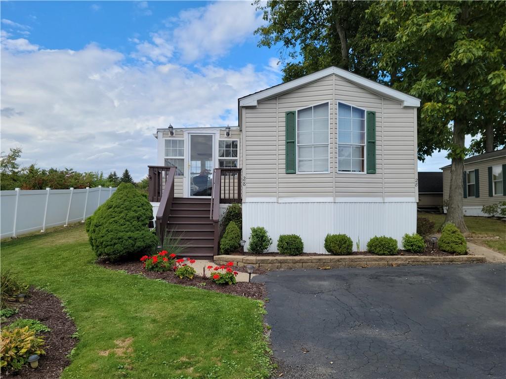 a front view of a house with a garden