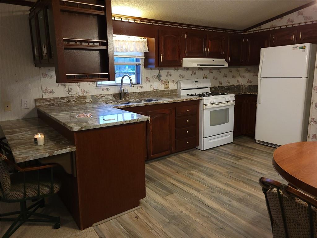 28 K And L Lane Butler, PA 16001 - Photo 12 of 18 a kitchen with a sink stove and refrigerator