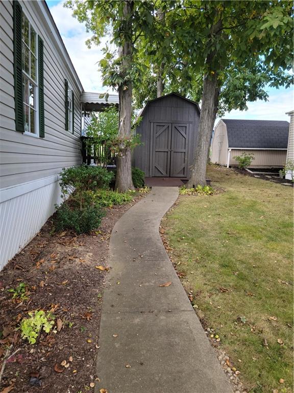 28 K And L Lane Butler, PA 16001 - Photo 4 of 18 a backyard of a house with a garden and tree