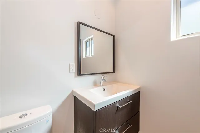 a bathroom with a sink toilet and mirror