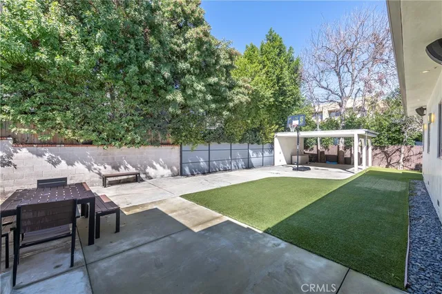 a view of a backyard with sitting area