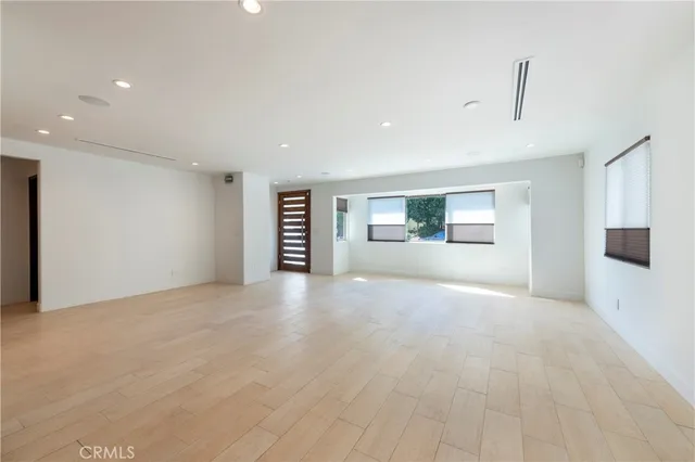 a view of a livingroom with an empty space and a window