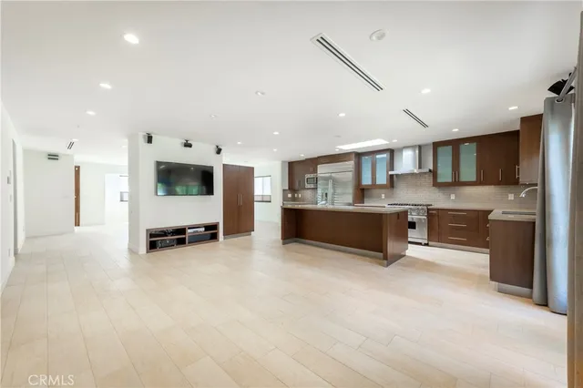 a large white kitchen with a stove and a refrigerator
