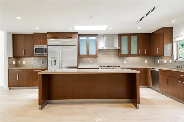 a kitchen with stainless steel appliances granite countertop a refrigerator and a sink
