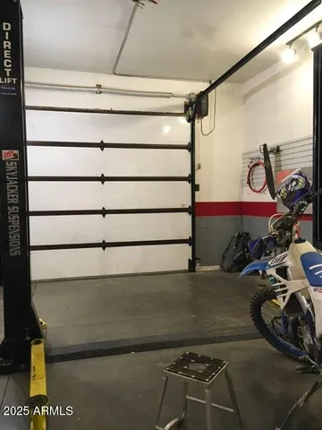 a view of a room with water heater and racks on the wall