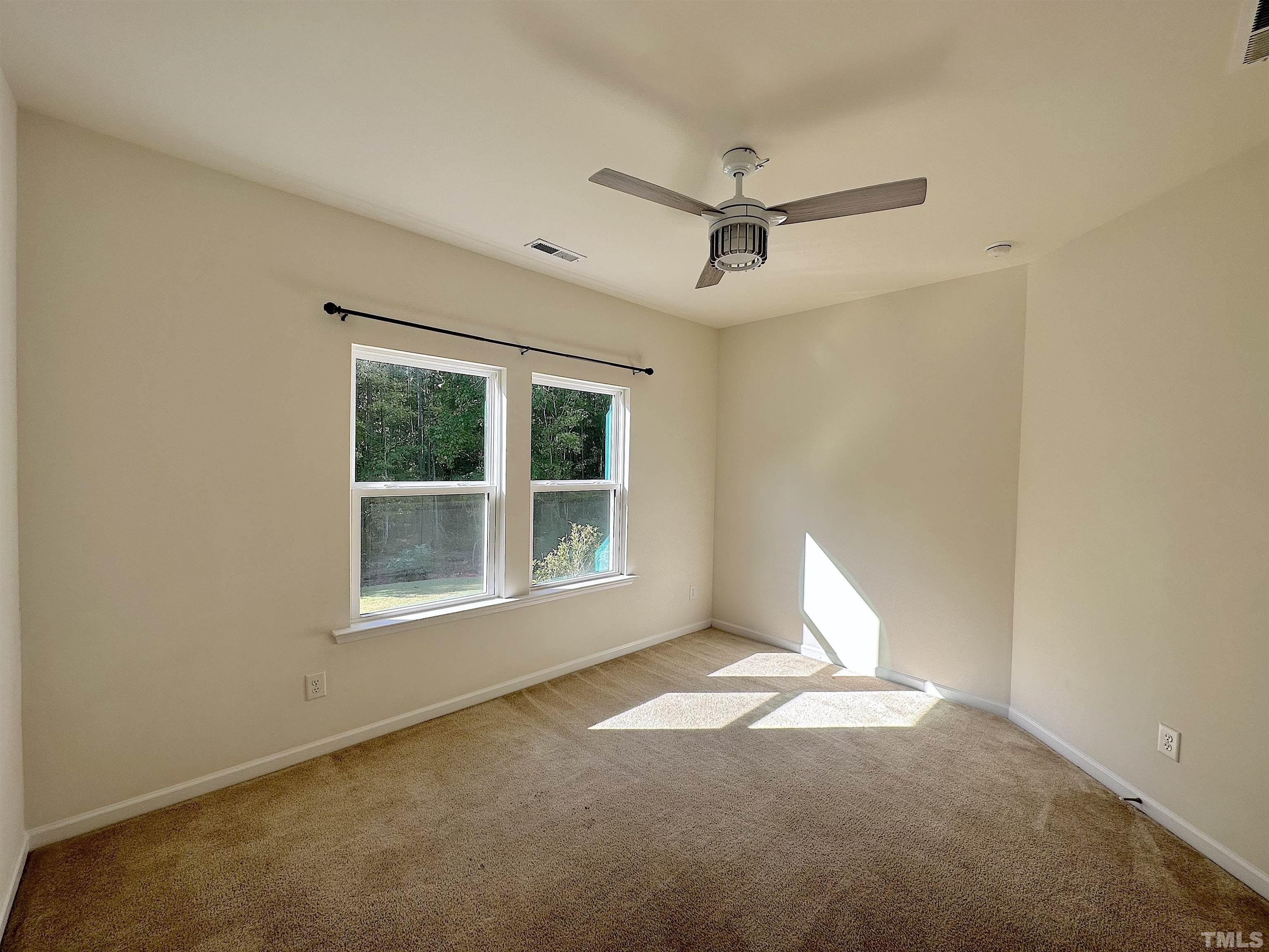 205 Azalea View Way Holly Springs, NC 27540 - Photo 12 of 29 a view of an empty room with a window