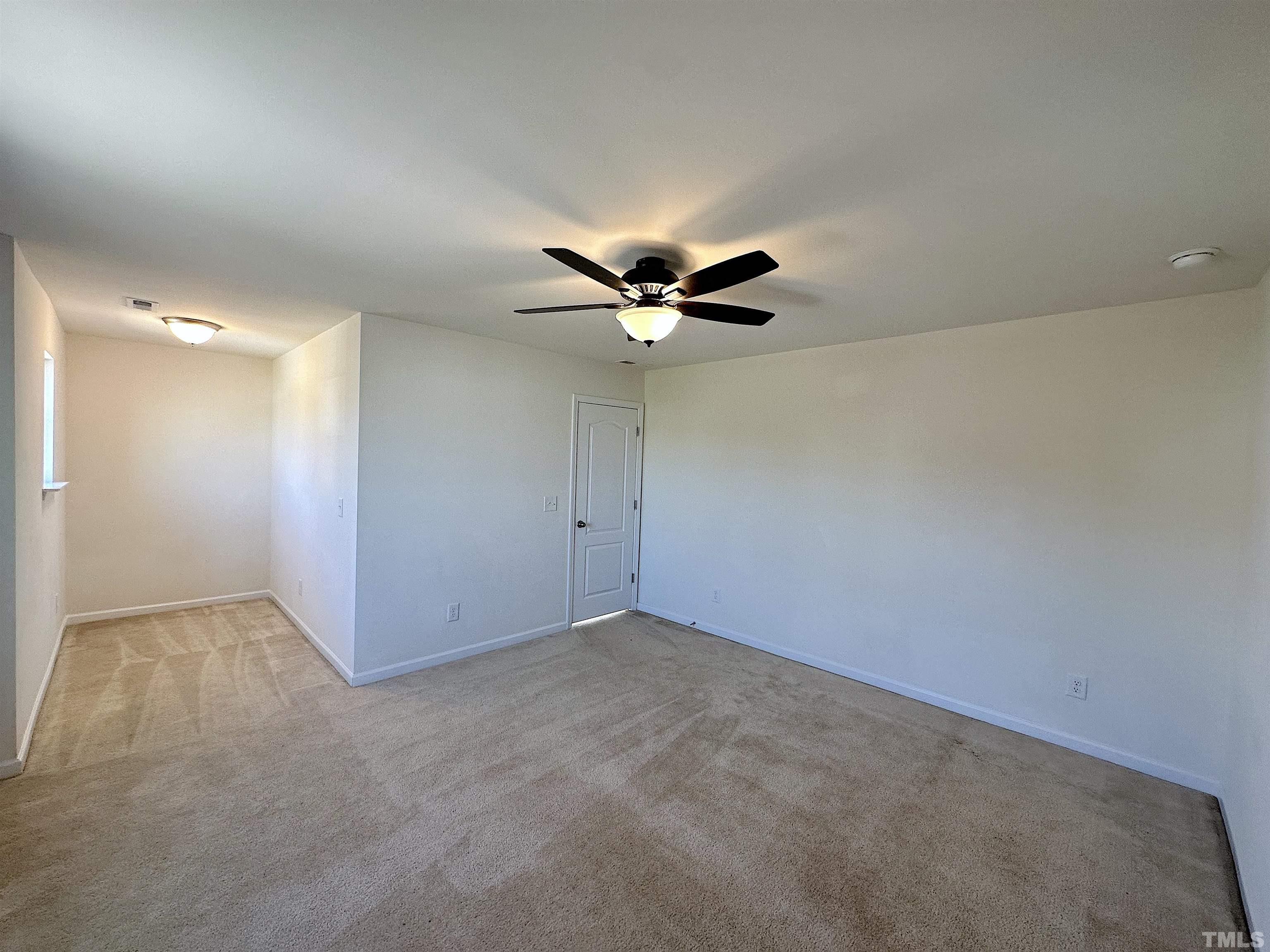 205 Azalea View Way Holly Springs, NC 27540 - Photo 14 of 29 an empty room with a ceiling fan and wooden floor