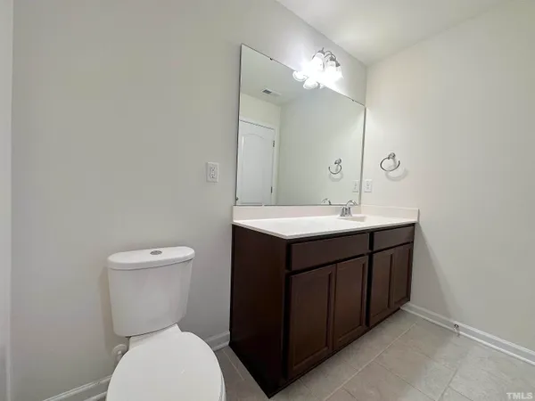 a bathroom with a sink vanity mirror and toilet