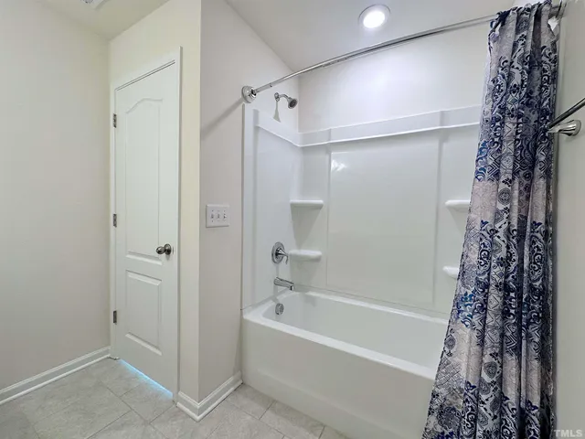 a bathroom with a bathtub and shower