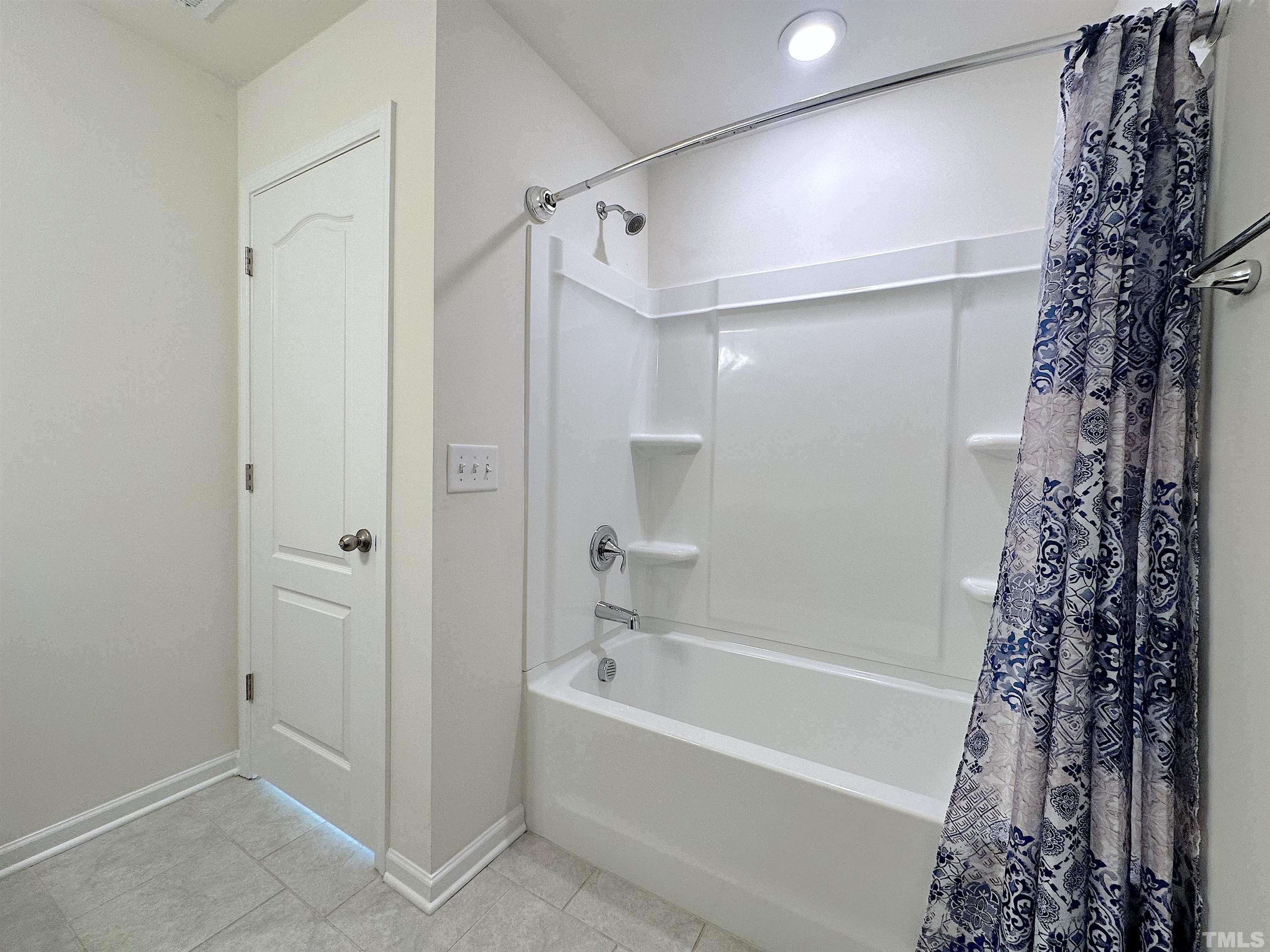 205 Azalea View Way Holly Springs, NC 27540 - Photo 18 of 29 a bathroom with a bathtub and shower