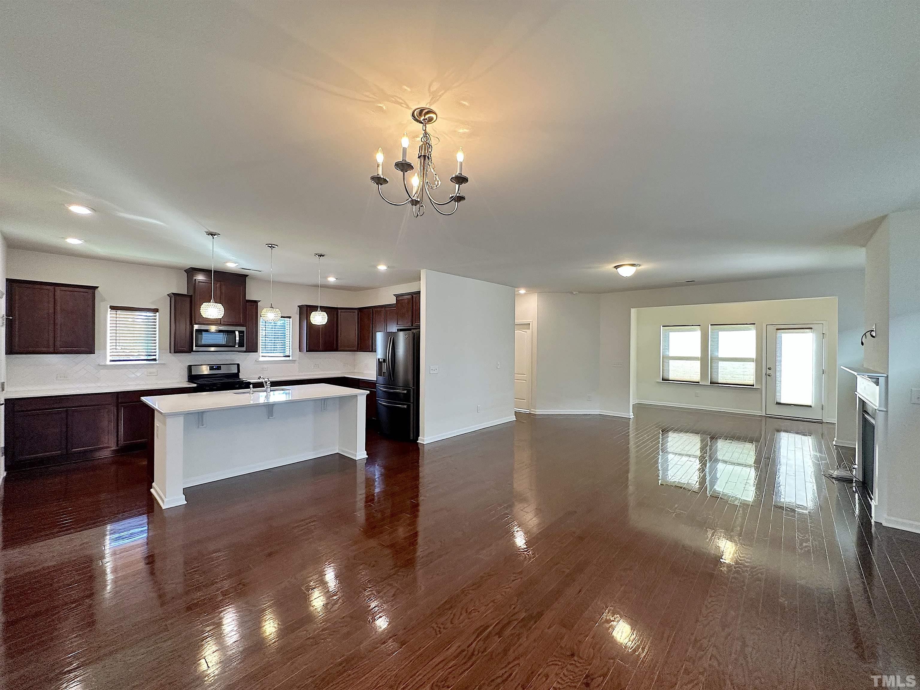 205 Azalea View Way Holly Springs, NC 27540 - Photo 2 of 29 a view of a living room and kitchen with stainless steel appliances