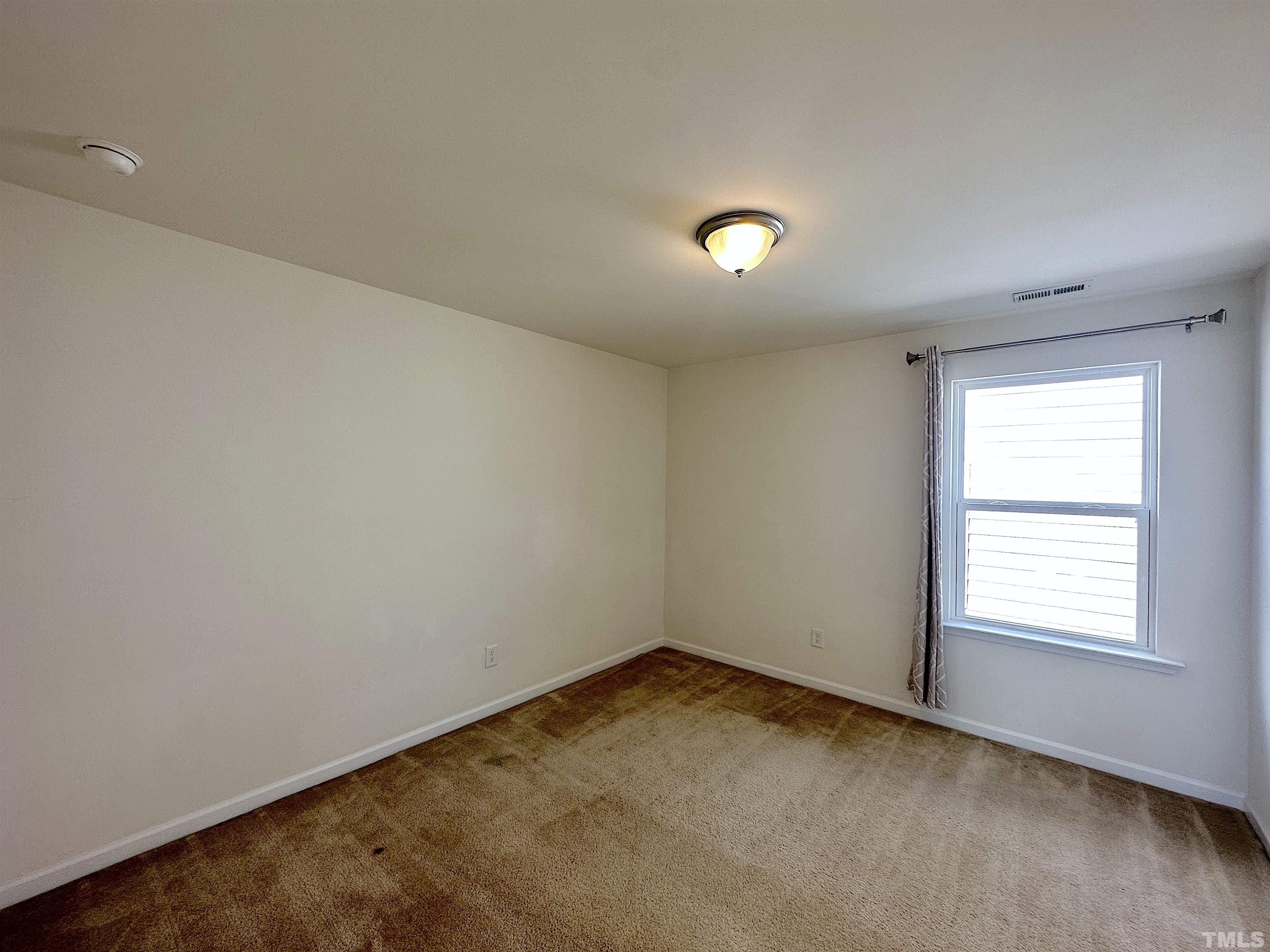 205 Azalea View Way Holly Springs, NC 27540 - Photo 22 of 29 an empty room with a window
