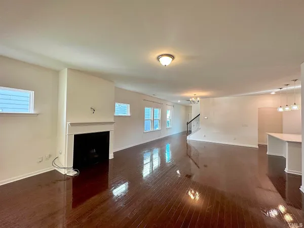 a living room with fireplace furniture and a wooden floor