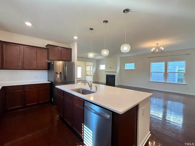 a kitchen with a sink cabinets and wooden floor