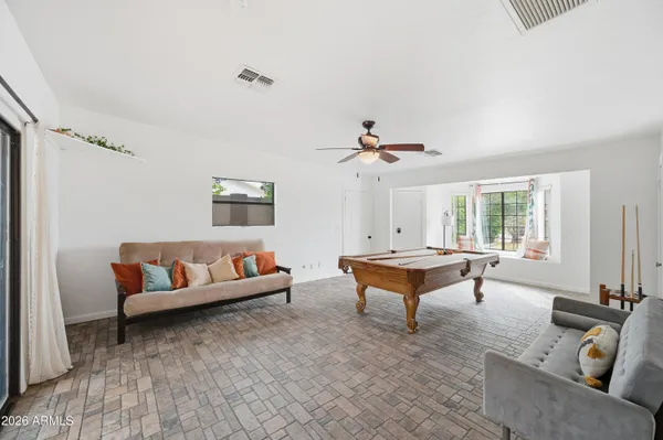 a room with chairs and window