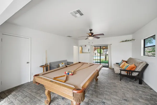a backyard of a house with table and chairs