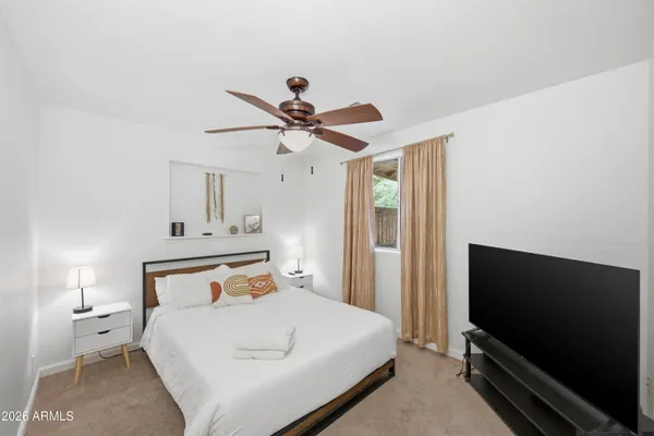 a bedroom with a bed and a flat screen tv