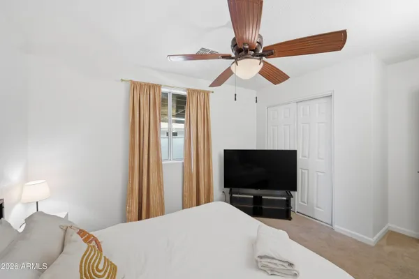 a bedroom with a bed and a couch