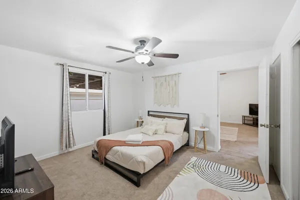 a bedroom with a bed and a chandelier