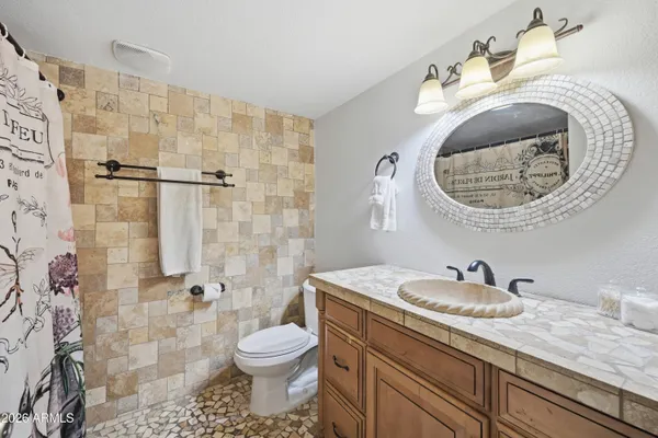 a bathroom with a sink toilet and shower